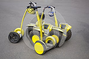 Rental bright yellow hoverboards with large wheels and bicycle safety helmets