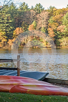 Rental canoes and kayaks along lakefront in autumn