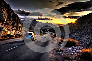 rental car in spain mountain landscape road at sunset