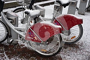 Rental citybike station covered by the snow in the street