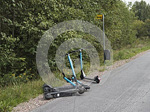 Rental electric scooters parked at a bus stop