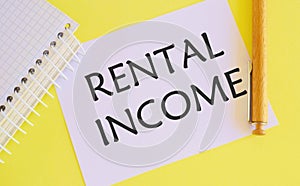 Rental income text written on white paper, Business concept photo showcasing amount of money collected by a landlord from a tenant