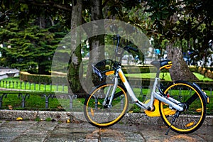 Rental public bike parked on a rainy day