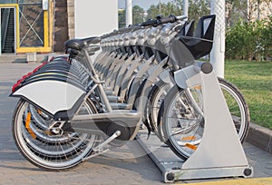 Rented bikes in row in parking lot