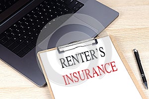 RENTER'S INSURANCE text on clipboard on laptop