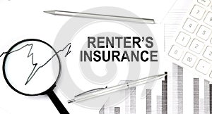 RENTER`S INSURANCE text on document with pen,graph and magnifier,calculator