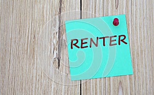 RENTER - word written on a green sheet for notes, which is pinned to a light wooden board