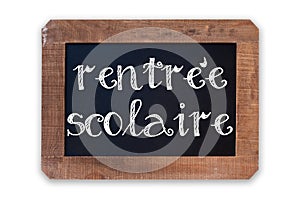 Rentree scolaire meaning Back to school written on a vintage blackboard with wooden frame isolated on white photo