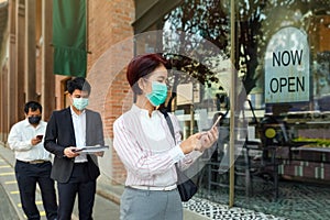 Reopened businesses after covid-19 lockdown , people wearing mask and keep social distancing to avoid the virus