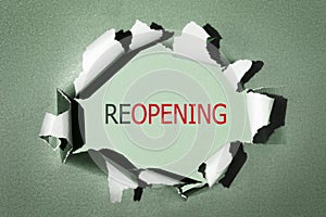 Reopening business, economy recovery after lockdown end concept. Word reopening on torn paper background