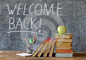 Reopening schools after corona lockdown, school supplies,books, blackboard with welcome message