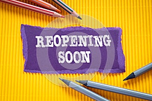 Reopening soon. Business concept. Text on torn, purple paper