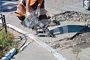 Repair of asphalt pavements and roads in the city center. patch holes in the asphalt on the roadway and the pedestrian. Job asphal photo