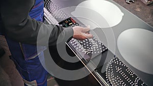 Repair and assembly of LED traffic lights at the factory close-up. A worker installs an anti-reflective diffuser. Light