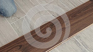Repair, building, floor and people concept - close up of man installing wood flooring