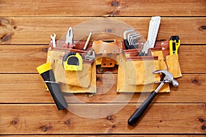 Different work tools in belt on wooden boards