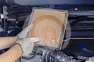 Repair and check car air conditioning system Technician holds car air filter to check cleanliness Clogging dirty or replacing the