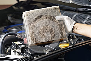 Repair and check car air conditioning system Technician holds car air filter to check cleanliness Clogging dirty or replacing the