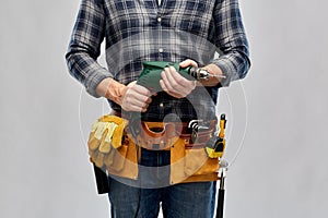 Male repairer or builder with drill and work tools