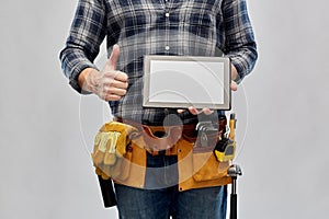 Male builder with tablet pc showing thumbs up