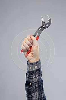 Close up of builder`s hand holding wrench