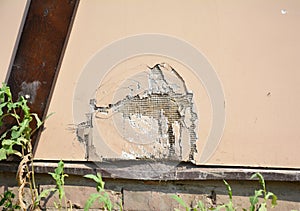 Repair cracks and holes in house wall stucco. Repairing a hole in a stucco wall will require a little patience and some practice.