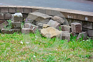 Repair damaged lawn guards. building blocks, bricks and a fragment of a decorative wall, fencing
