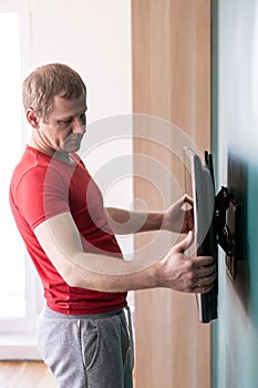 Repair and decoration. `husband for an hour` service. man hangs tv on the wall