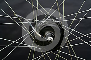 Repair of electric bicycles. Bicycle wheel, spokes and electric motor close-up on a black background