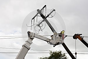 Repair of electricity pole on a cloudy day