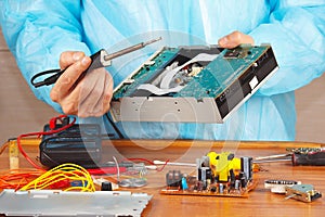 Repair electronic hardware with a soldering iron in service workshop