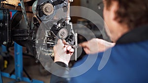 Repair of the engine of the car, the repairman is engaged in restoration of the engine of the motor