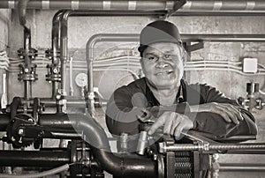 Repair engineer for heating system equipment in the basement of a building, portrait. Plumbing, maintenance and repair.