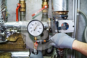 Repair of equipment in an industrial boiler room. The process of installing and tightening nuts in the heating system. A plumber