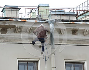 Repair of a facade of a house by the industrial climber