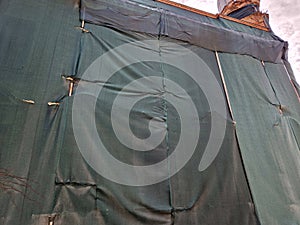 repair of the facade of the house. The scaffolding is covered with a