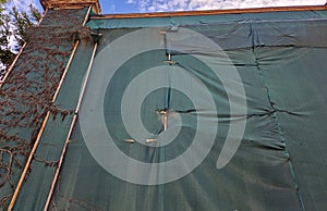 repair of the facade of the house. The scaffolding is covered with a