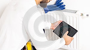 Repair heating radiator close-up. man repairing radiator with wrench. Removing air from the radiator