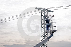 repair of high voltage power line on the pole