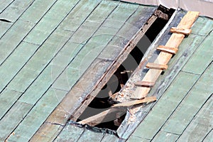 Repair of hole in a metal roof