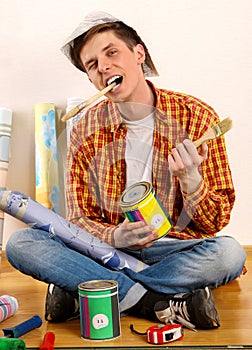 Repair home man holding paint roller for wallpaper.