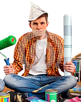 Repair home man holding paint roller for wallpaper.