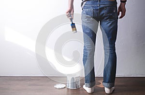 Arreglar de casa hombre es un común sobre el pintar muro cepillar en blanco. pintar gotas cepillar 