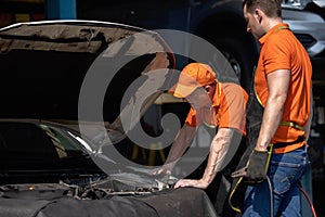 Repair Man Worker Polishing Automobile Car Body In Garage