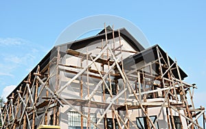 Repair, Painting and Plastering Exterior House Scaffolding Outdoor. Stucco Facade Home.