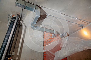 Repair and restoration of apartment drainpipes and ventilation. Empty room without decoration.