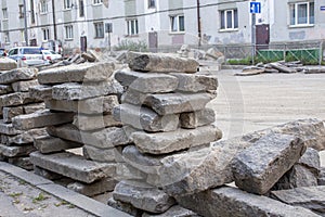 Repair of roads.the curb from the dismantled road lies on the asphalt