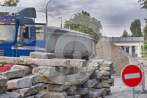 Repair of roads.the curb from the dismantled road lies on the asphalt