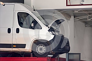 Repair shop for minibuses, car maintenance. Professional workshop for auto service. Open engine hood photo