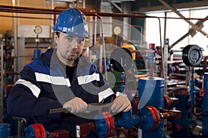 A repair technician makes a caliper gauge a flange connection on the fittings of gas equipment